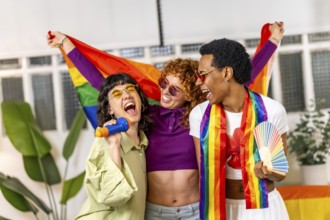 Multi-ethnic and gender friends singing karaoke and raising lgbt rainbow flag at home