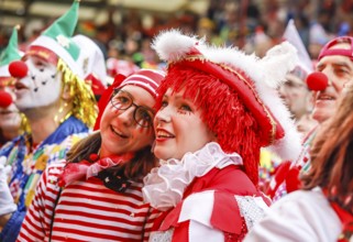 Colourfully costumed carnivalists celebrate carnival in Cologne, on Weiberfastnacht the street