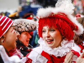 Colourfully costumed carnivalists celebrate carnival in Cologne, on Weiberfastnacht the street