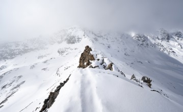 View of wintry mountain landscape on the ridge of Piz Laviner, Grisons Haute Route, Albula Alps,