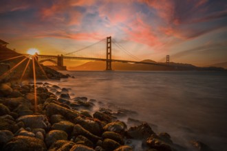 Gorgeous orange sunset with pink clouds over the Golden Gate in San Francisco, California. United