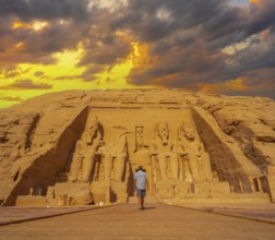 A young man walking towards the Abu Simbel Temple in southern Egypt in Nubia next to Lake Nasser.