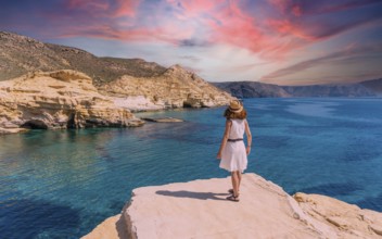 A young woman in a white dress looking at the sea in Rodalquilar in Cabo de Gata on a beautiful