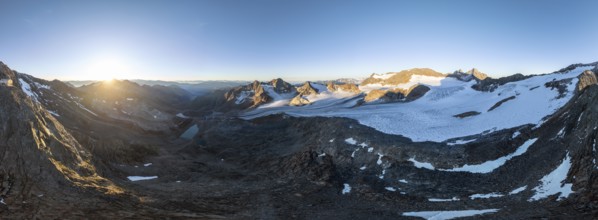 Atmospheric sunrise in a picturesque mountain landscape, alpenglow, aerial view, at the summit