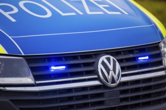 Police car with flashing blue lights in action