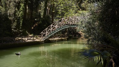 Wooden bridge over a green river, surrounded by dense forest, Rodini Park, City Park, Rhodes Town,