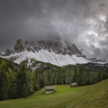 View of a part of the Geisler group in the foreground two mountain huts, Dolomites, snow,