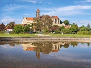 Castle hill with collegiate church of St. Servatius with reflection in water basin in autumn,