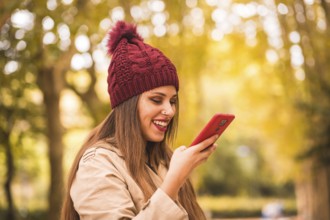 Portrait of a beautiful woman in autumn together in a forest in nature on a video call