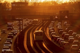 Motorway A40, dense, slow-moving traffic jam, evening traffic at the Essen-Kray junction, low sun,