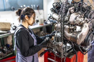 Skilled mechanic assembling engine parts in a professional workshop, showcasing expertise and