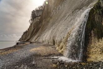Waterfall of the Kiel stream on the Kiel shore and the famous chalk cliffs on the Baltic Sea coast