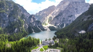 Stunning aerial view of lake braies with the iconic seekofel mountain and a charming hotel nestled