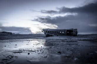 Plane wreck, crahsed plane on frozen Solheimasandur beach in winter with snow in Iceland