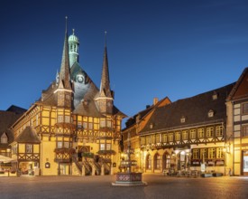 Market square, market fountain, historic town hall and half-timbered houses at dusk, Wernigerode,