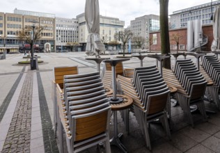 Deserted city centre with closed restaurants and shops due to corona pandemic contact ban,