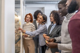 Side view of a group of colleagues during a brainstorming process in a coworking space using sticky