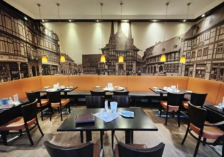 Interior photo of cafe with photo wallpaper of the market square with the town hall, old town,