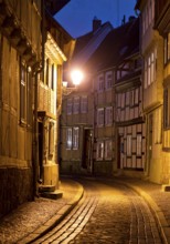 Half-timbered houses in a narrow street with cobblestones, Old Town in the evening, World Heritage