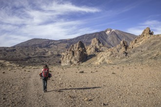 Female hiker walking towards Mount Teide, El Teide, Pico del Teide, volcano in the Teide National