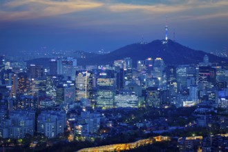 Seoul downtown cityscape illuminated with lights and Namsan Seoul Tower in the evening view from