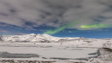 Northern Lights, Aurora Borealis, over snow-covered landscape at Skalafellsjökull, Sudurland,