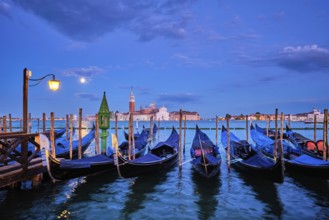 Romantic vacation Venice travel background, gondolas at Saint Mark (San Marco) square and Basilica
