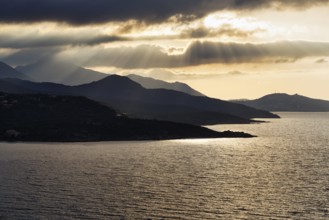 Coastline backlit, sun rays through clouds, L'Île-Rousse, Ile Rousse, Haute-Corse, Balagne, North