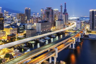 Kobe skyline from above with harbour and elevated roads at night in Kobe, Japan, Asia