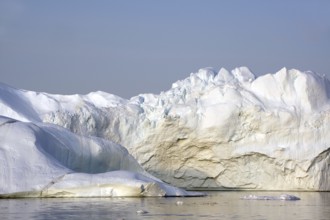 Giant iceberg in the glow of the midnight sun Disko Bay, Ilulissat, Arctic, Greenland, Denmark,