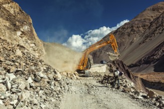 LADAKH, INDIA, SEPTEMBER 10, 2011: Excavator cleaning road after landslide in Himalayas. Ladakh,