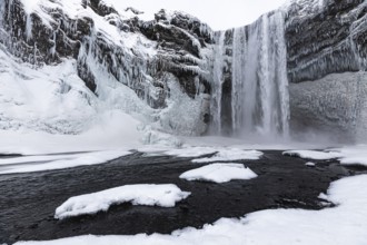 Skogafoss waterfall, snowy and icy rock face, Sudurland, Iceland, Europe