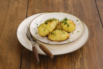Portion of crispy hasselback potato on a plate