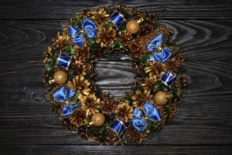 Christmas wreath on dark wooden background