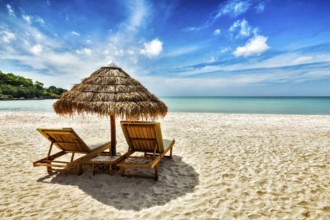 Vacation holidays background wallpaper, two beach lounge chairs under tent on beach. Sihanoukville,