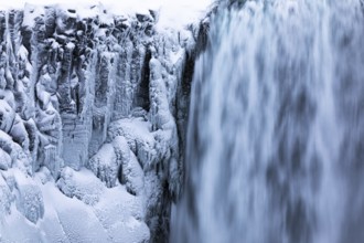 Dettifoss waterfall with icy and snow-covered rock face, Northern Iceland Eyestra, Iceland, Europe