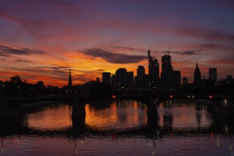 The silhouette of Frankfurt's banking skyline stands out against the luminous evening sky in the
