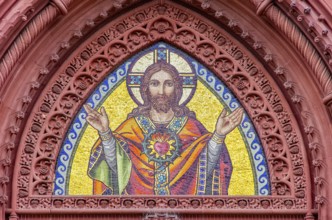 Musical depiction of Jesus Christ in the pointed arch of the main portal of the Church of the