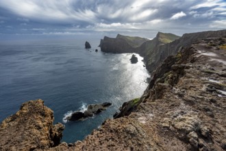 Red cliffs and rocks in the sea, coastal landscape with dramatic sky, Ponta de São Lourenço,