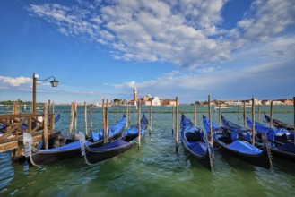 Gondolas and in lagoon of Venice by Saint Mark (San Marco) square with San Giorgio di Maggiore
