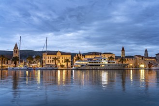 Cruise ship in front of the old town centre of Trogir at dusk, Croatia, Europe