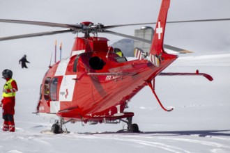 25 March 2024, Grindelwald, Switzerland: Rescue helicopter in action after a skiing accident