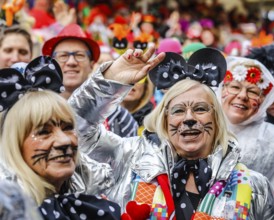 Colourfully costumed carnivalists celebrate carnival in Cologne, on Weiberfastnacht the street