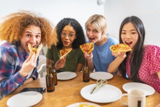 Group of young diverse friends eating pizza slices and drinking beer, having fun together at home