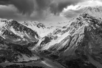 Dark clouds over the snow-covered mountains, black and white photo, above Saint Luc, Val