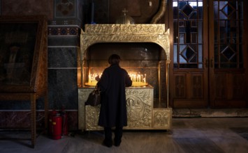 Woman offering a candle, from behind, interior view of Hagia Sofia church, also Agia Sofia, dome,
