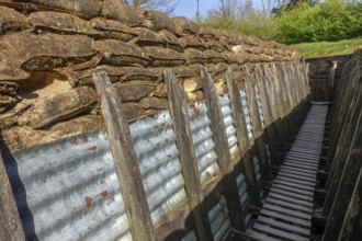 British WW1 trench showing wooden duckboards on A frames, sandbags and sheets of corrugated iron at
