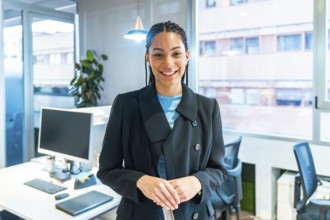 Portrait of a businesswoman smiling in a modern office, showcasing confidence and professionalism