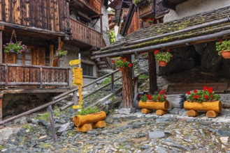 Signpost for hiking trails in the historic town centre, Grimentz, Val d'Anniviers, Valais Alps,