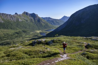 Mountaineers on a hiking trail to the summit of Rundfjellet, mountain landscape and valley with